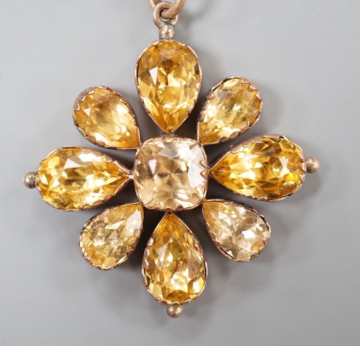 A 19th century yellow metal and foil backed paste set pendant, 42mm, on a later 375 chain, gross weight 12.9 grams.